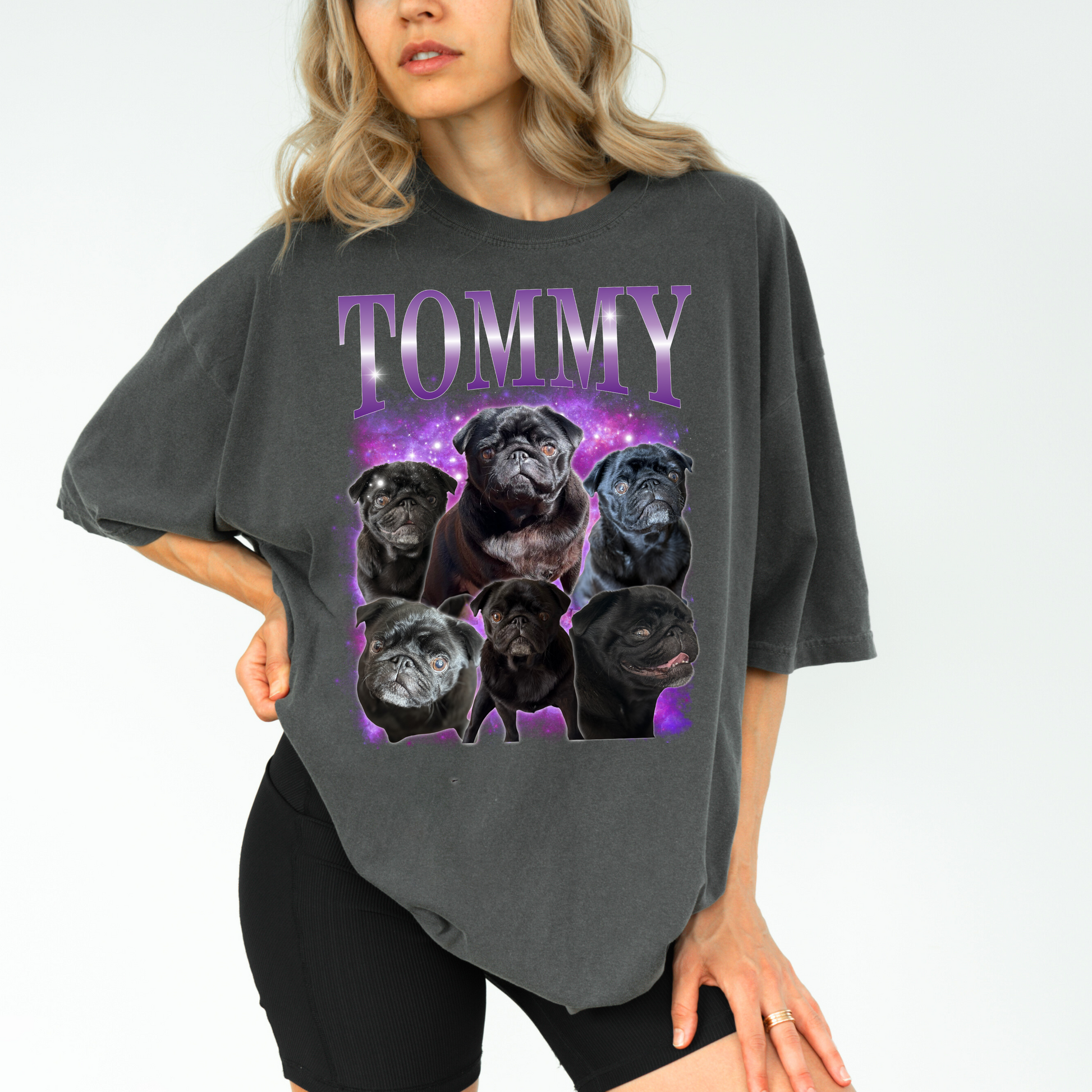 a woman wearing a gray t - shirt with a picture of dogs on it